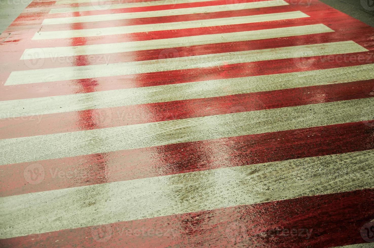 Zebra crossing sign on a wet road. Asphalt road with zebra crossing. photo