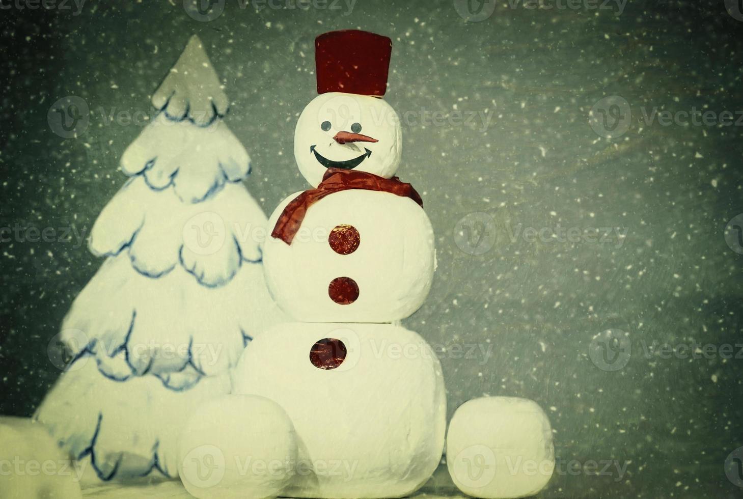 Cheerful vintage snowman on the background of a white drawn Christmas tree. photo