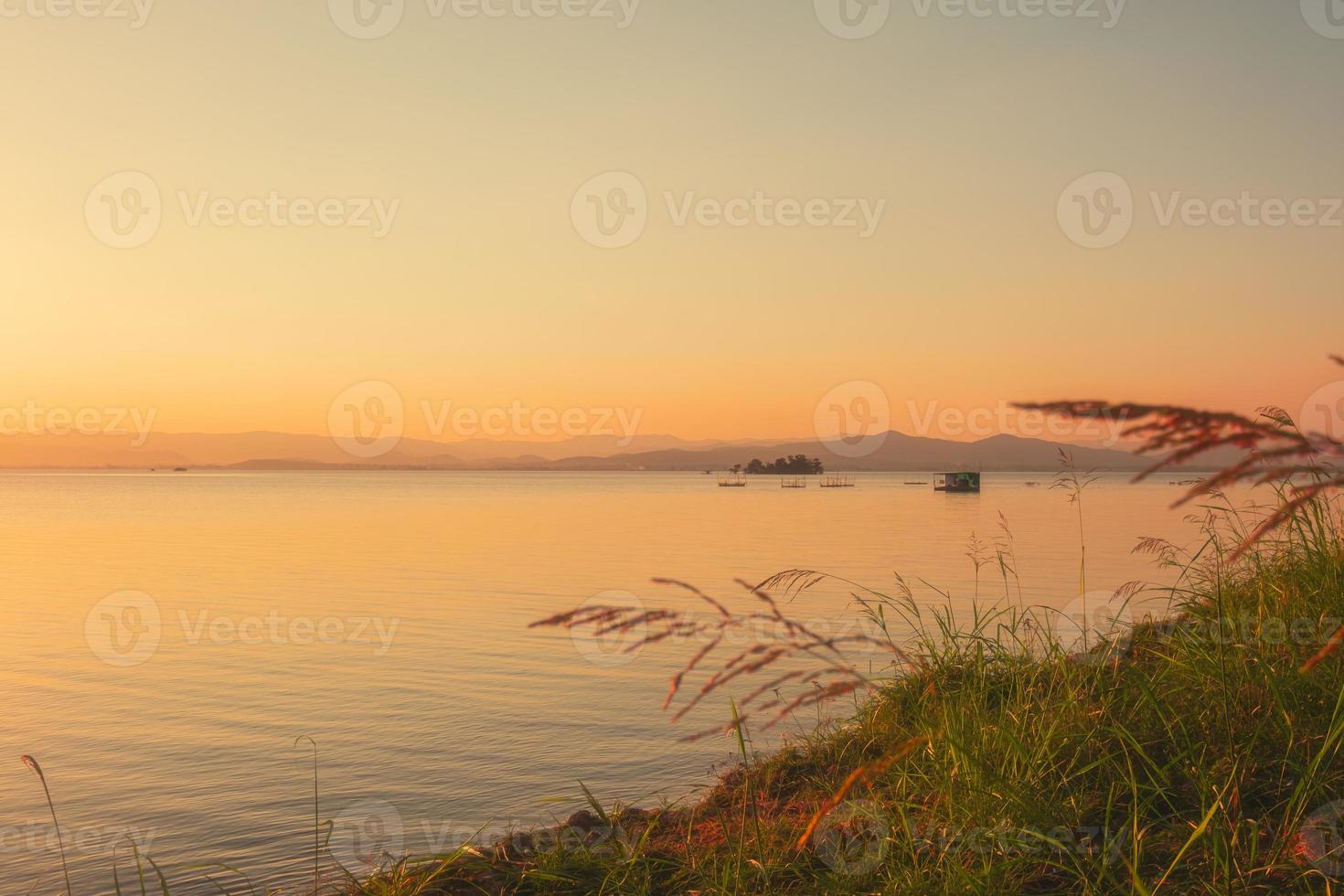 On the shore of the lake in the late afternoon photo