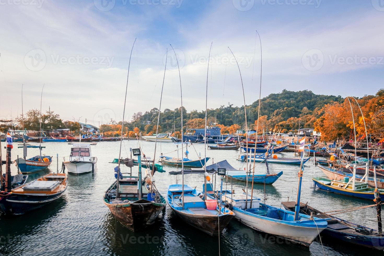 Numerous small fishing boats moored in front of the fishing village. photo