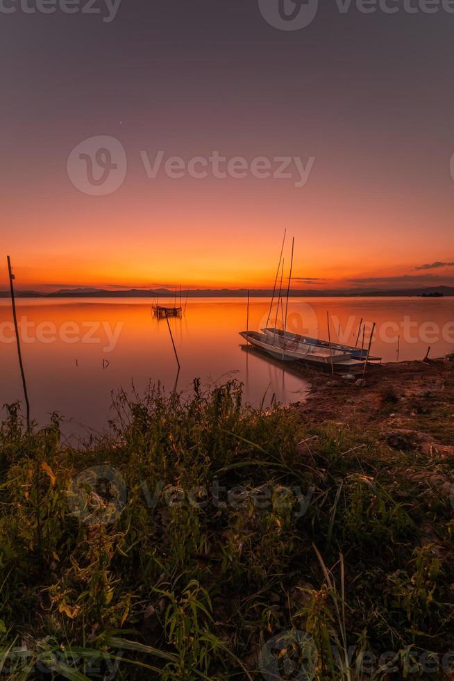 Two small boats moored on the shore of the lake. at sunset beautiful light photo