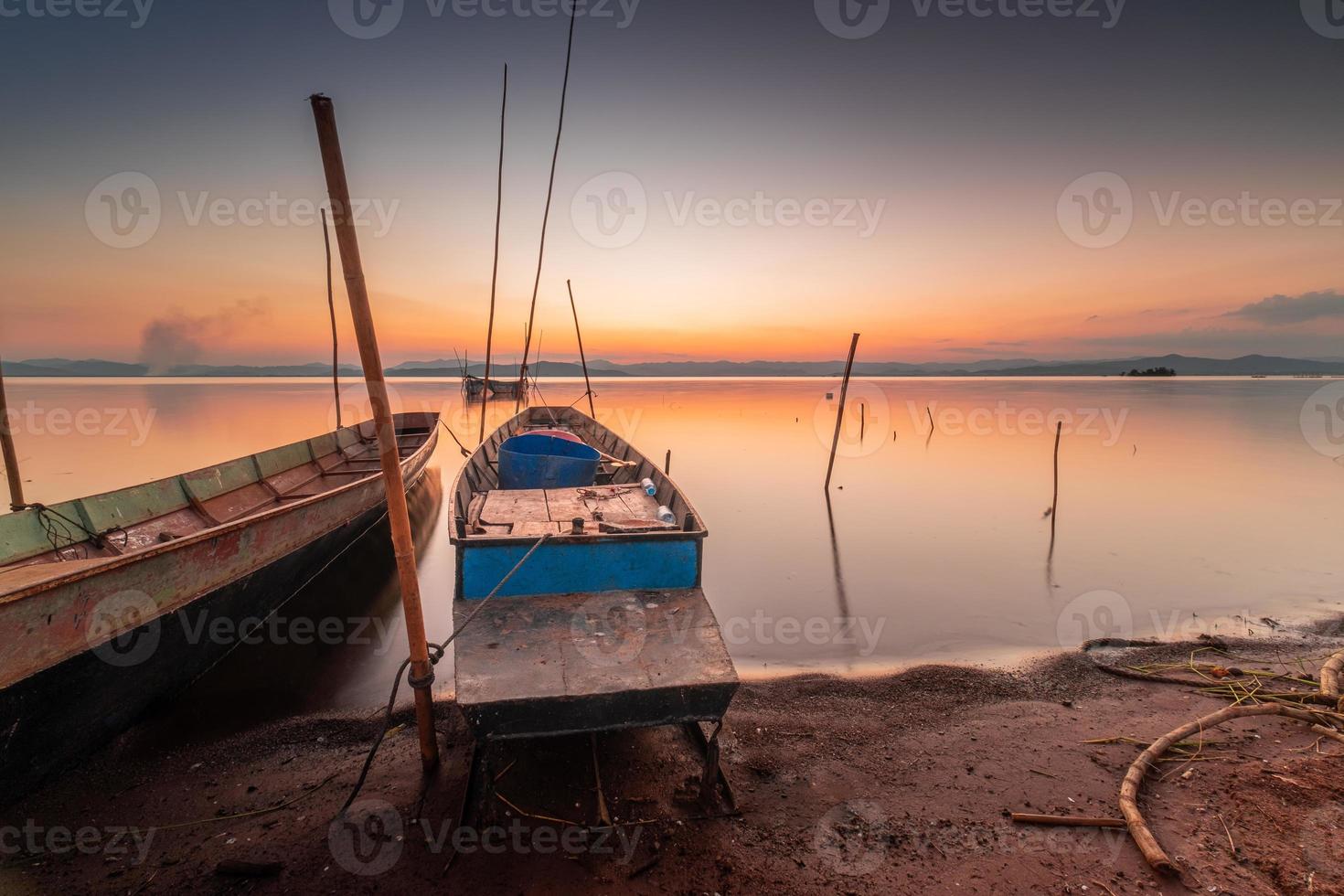 Two small boats moored on the shore of the lake. at sunset beautiful light photo