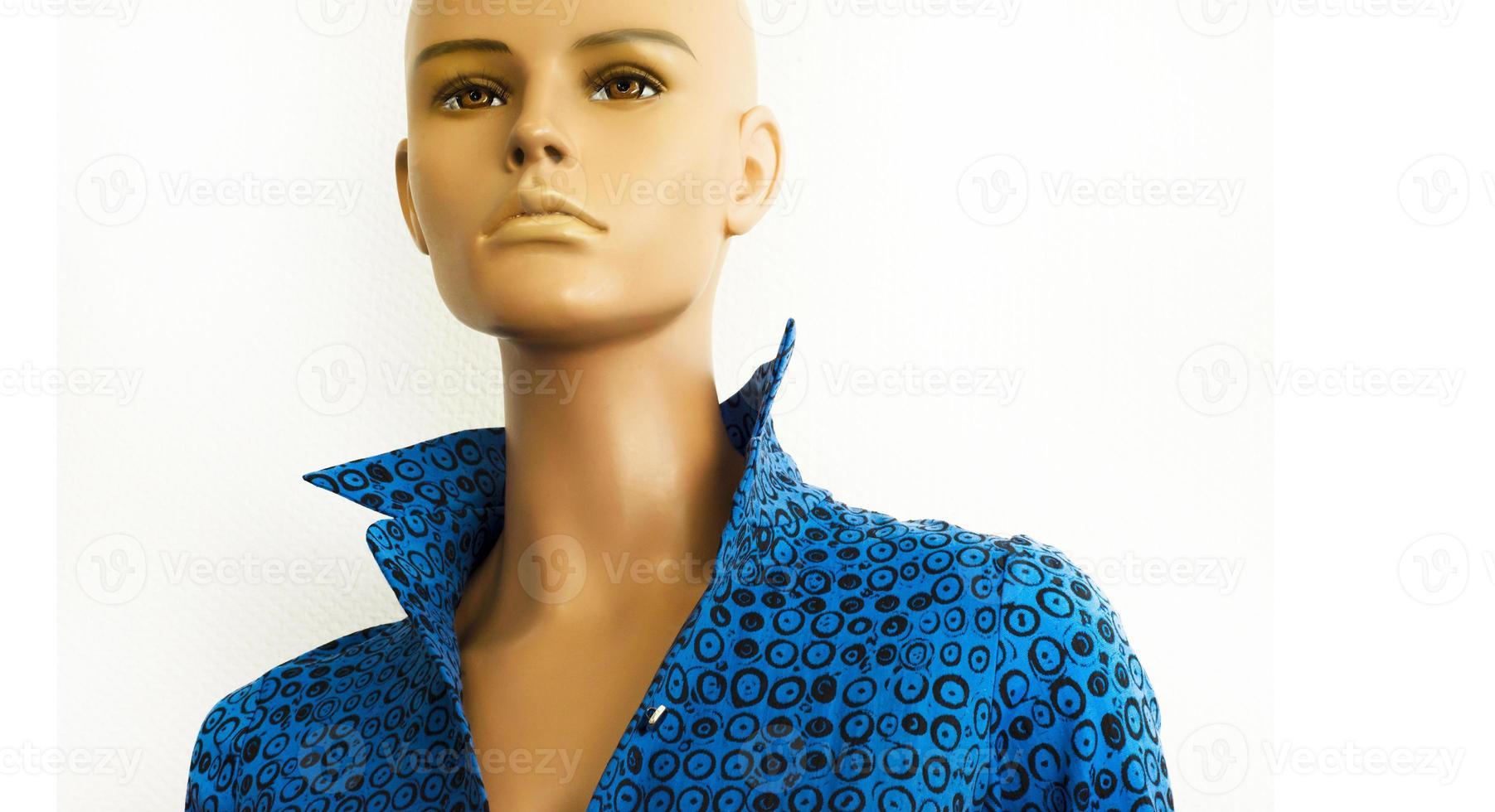 Portrait of a mannequin without hair in a blue shirt with a stand-up collar. Trends and styles in clothes. Women's fashion. Boutique. Tailor Tailoring to order. Sales of clothes. Copy space for text. photo
