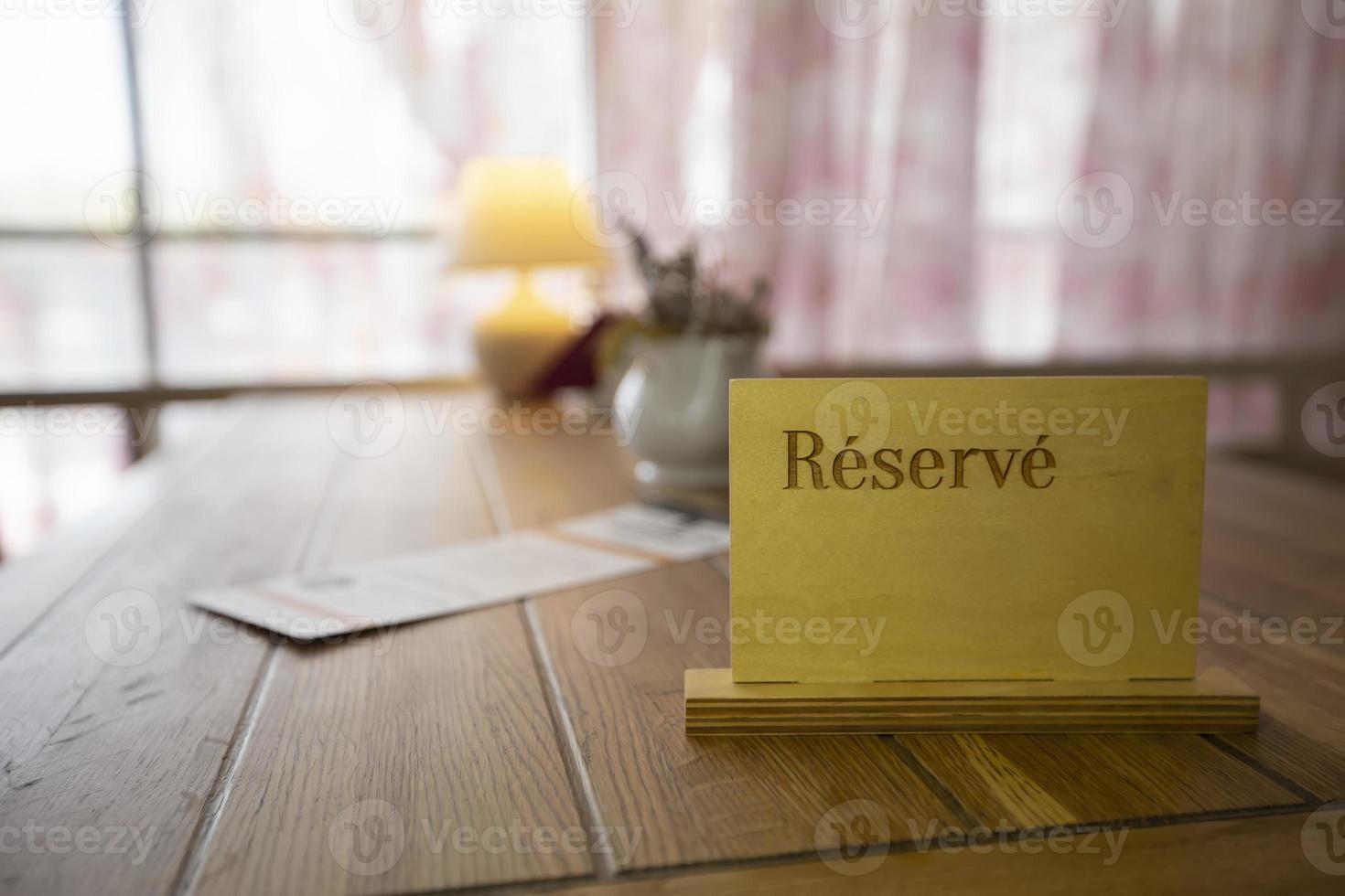 Reserved sign on a table in restaurant photo