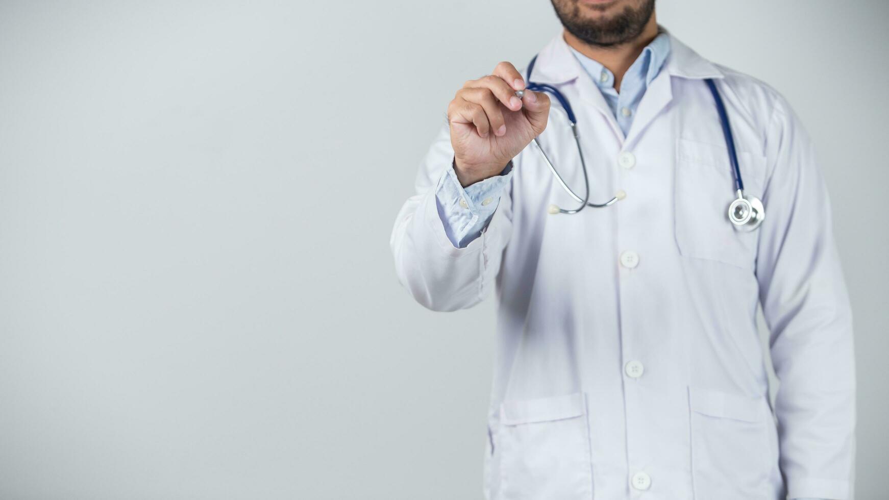 male doctor is holding stethoscope into the camera photo