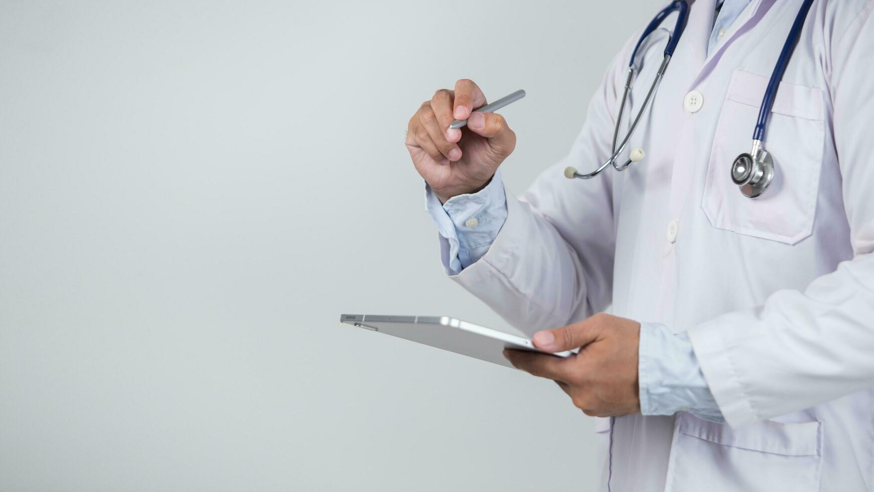 male doctor is holding stethoscope into the camera photo