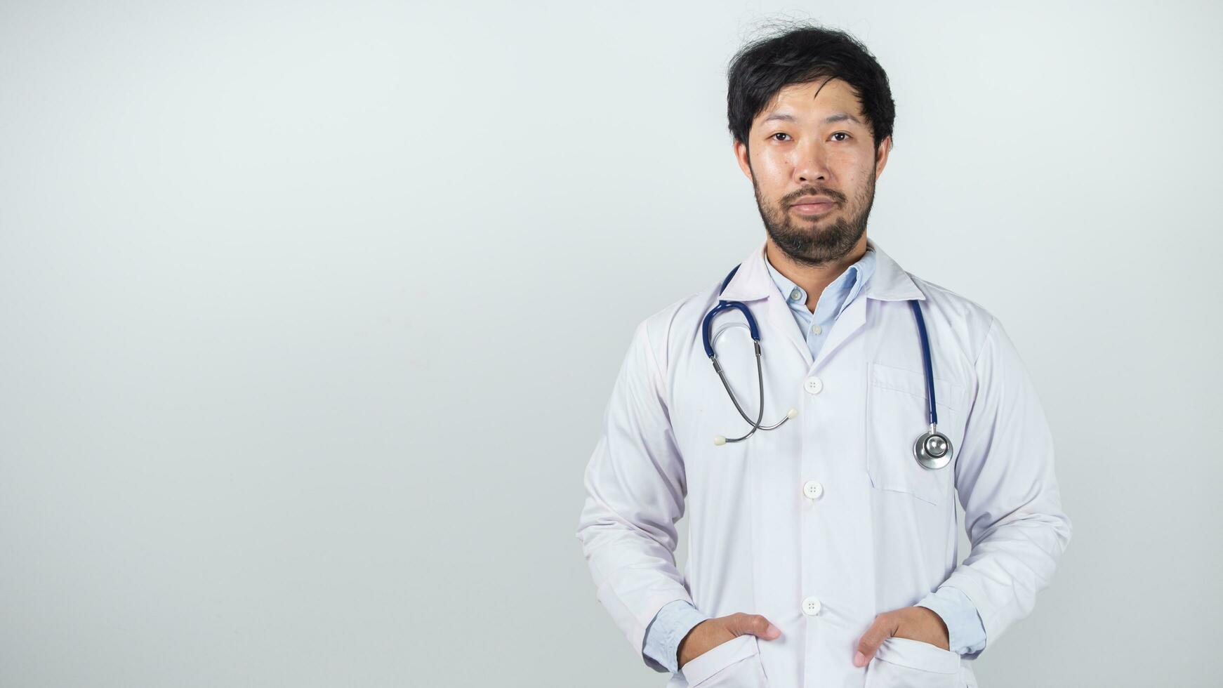 male doctor is holding stethoscope into the camera photo