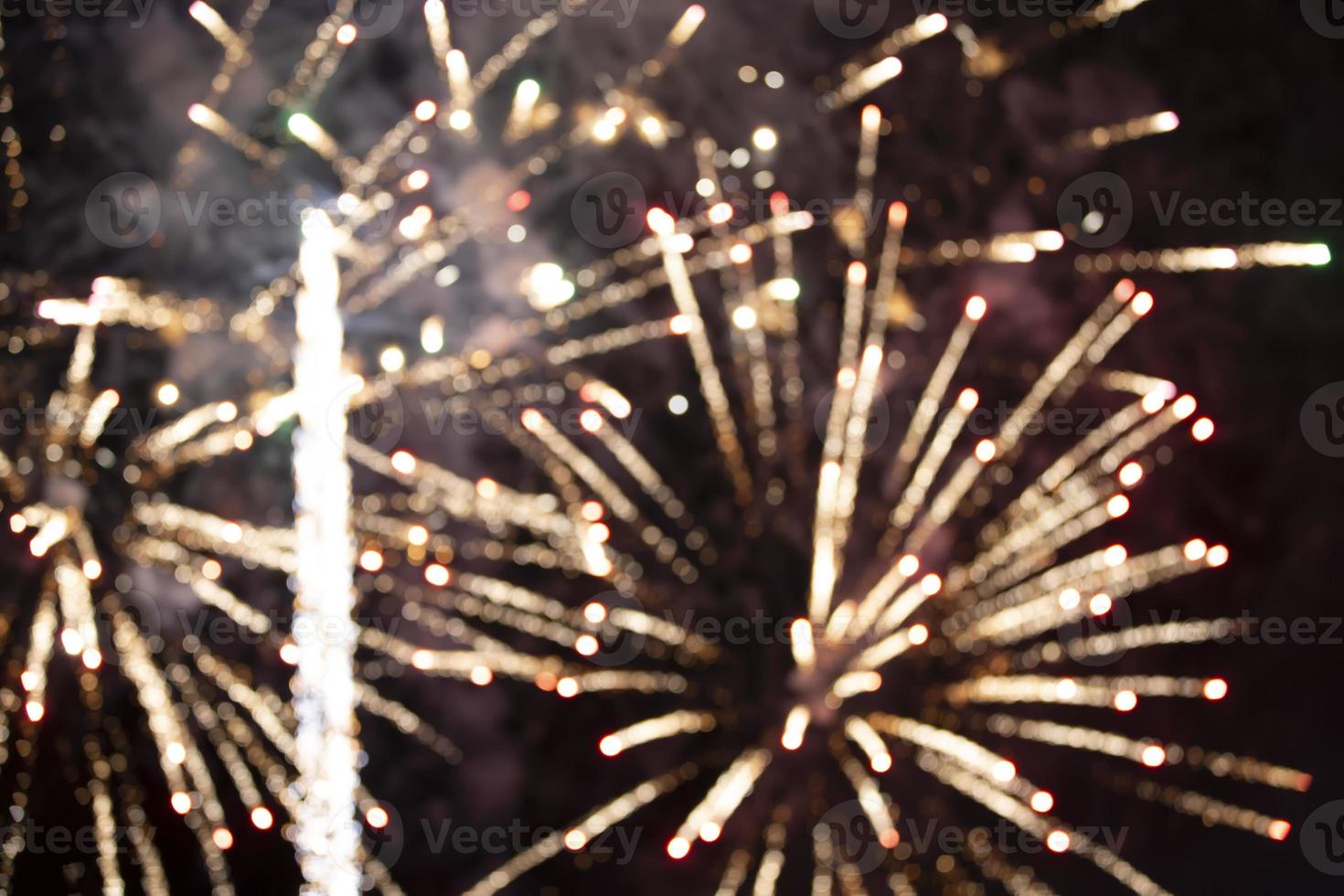 On a black background bokeh from explosions of colorful fireworks. photo