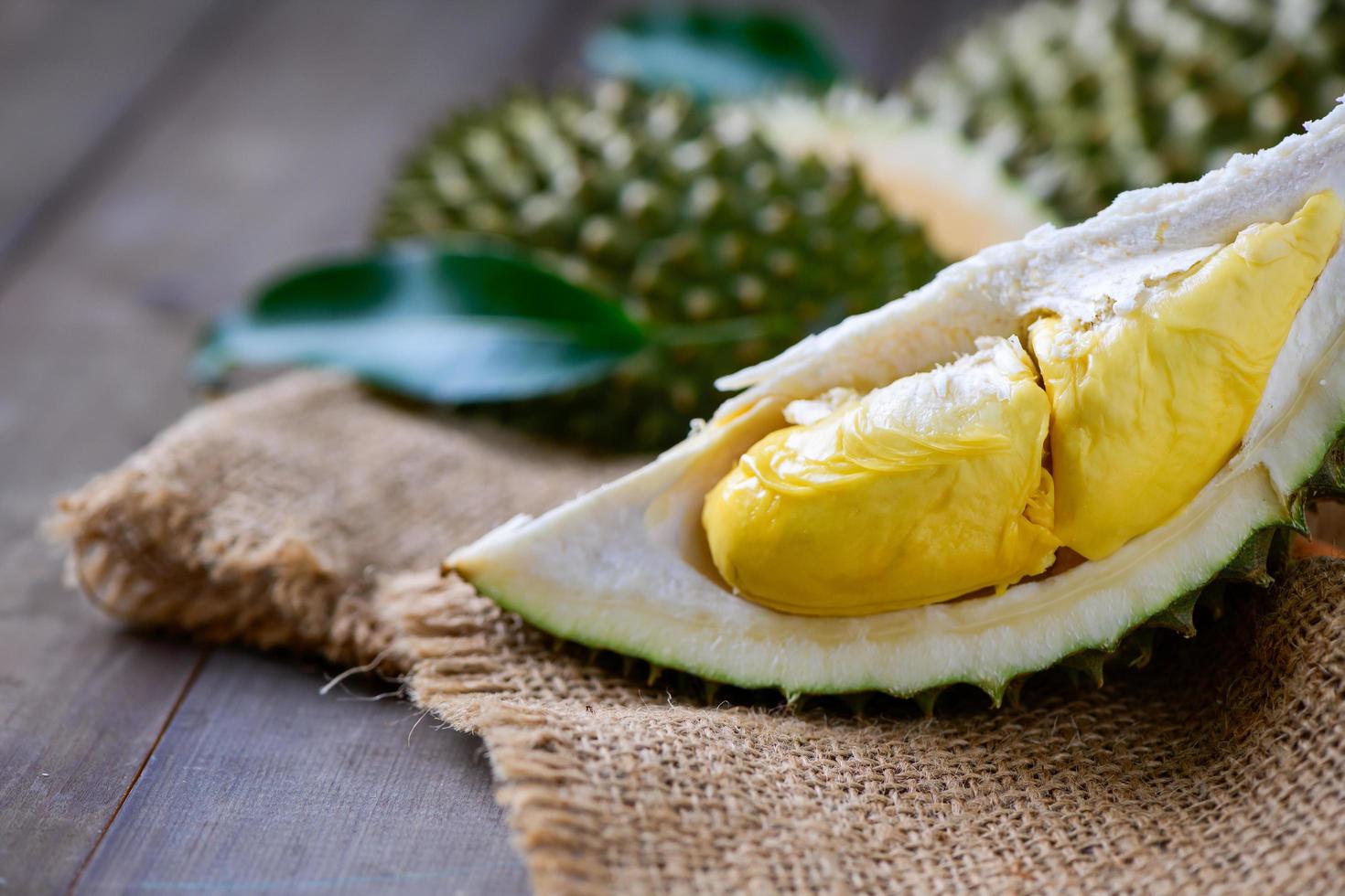 Puangmanee durian on wood plate and wood background, It's a small durian. v photo