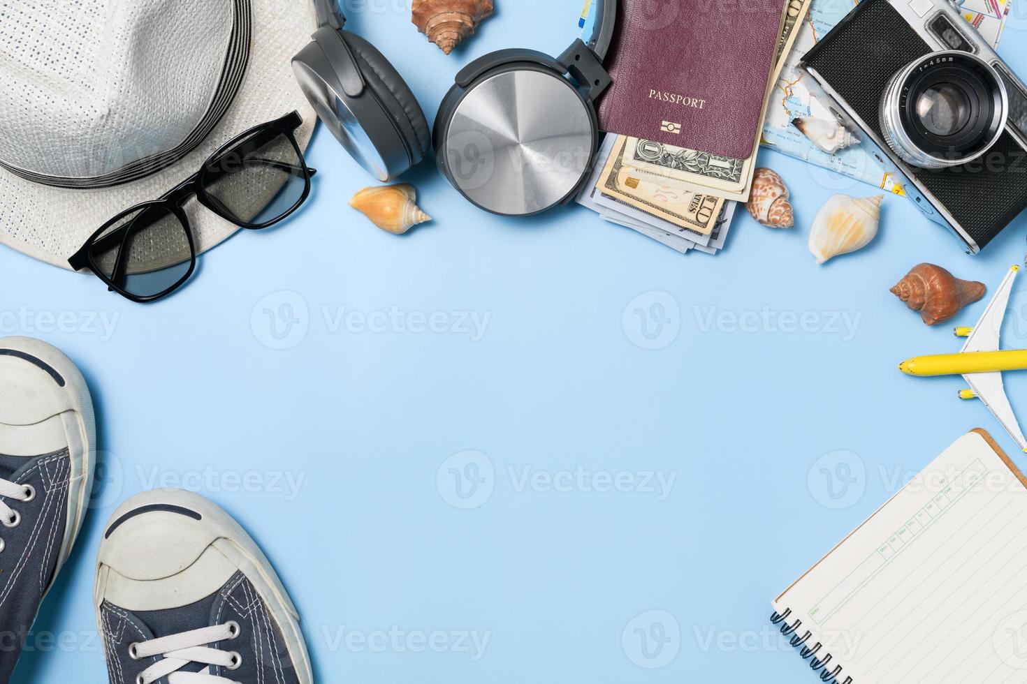 Traveler accessories, vintage camera, dollar banknote in passport and black sneaker photo