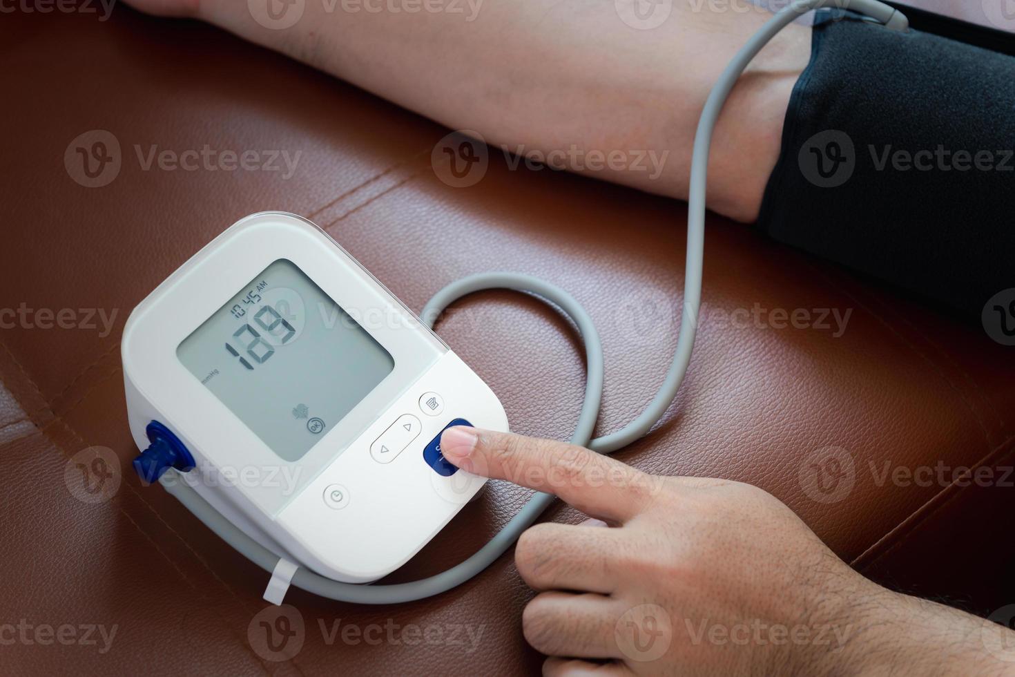 Men's health check blood pressure and heart rate with digital pressure gauge photo