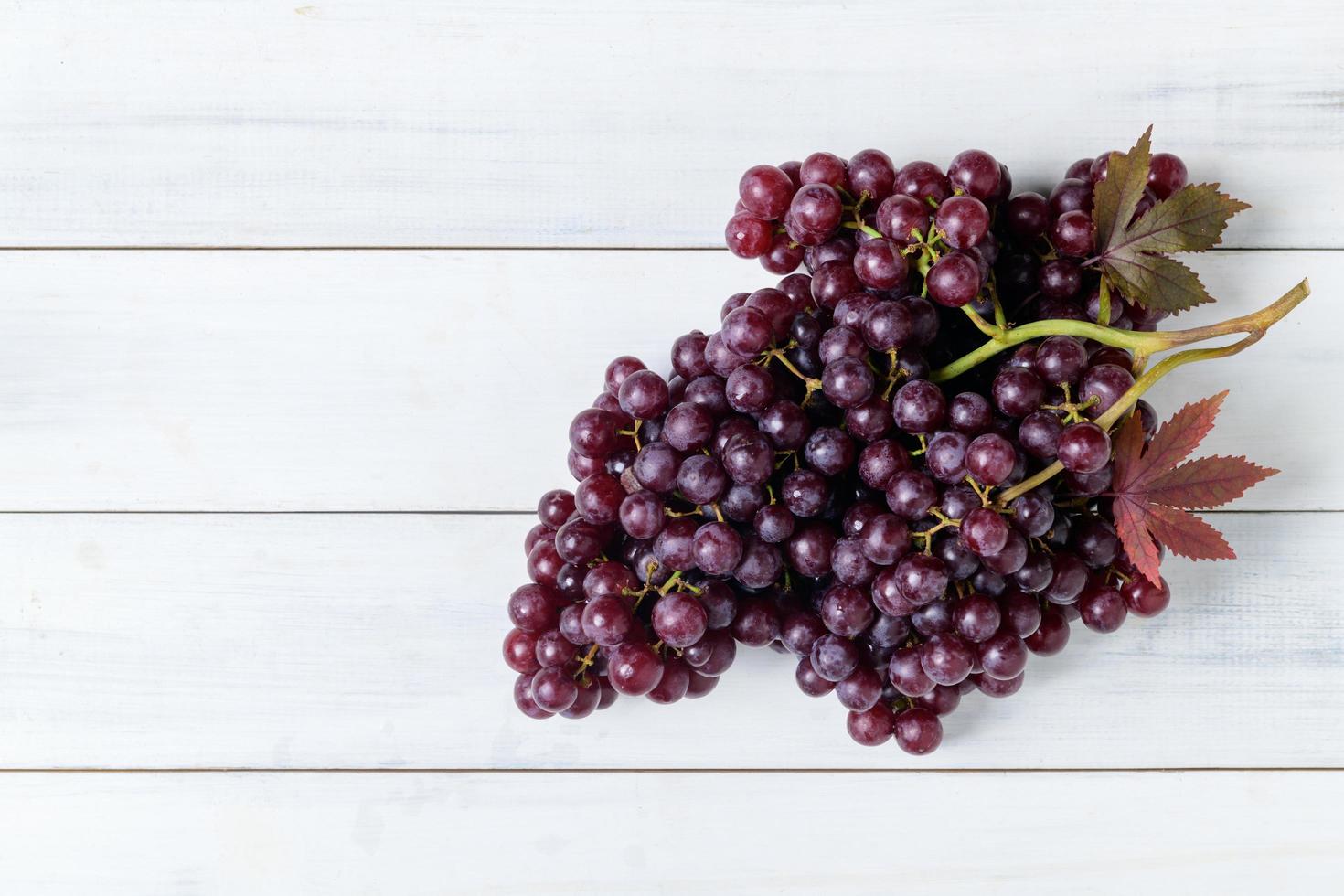 Champagne grapes on white wood background. Fruits concept photo