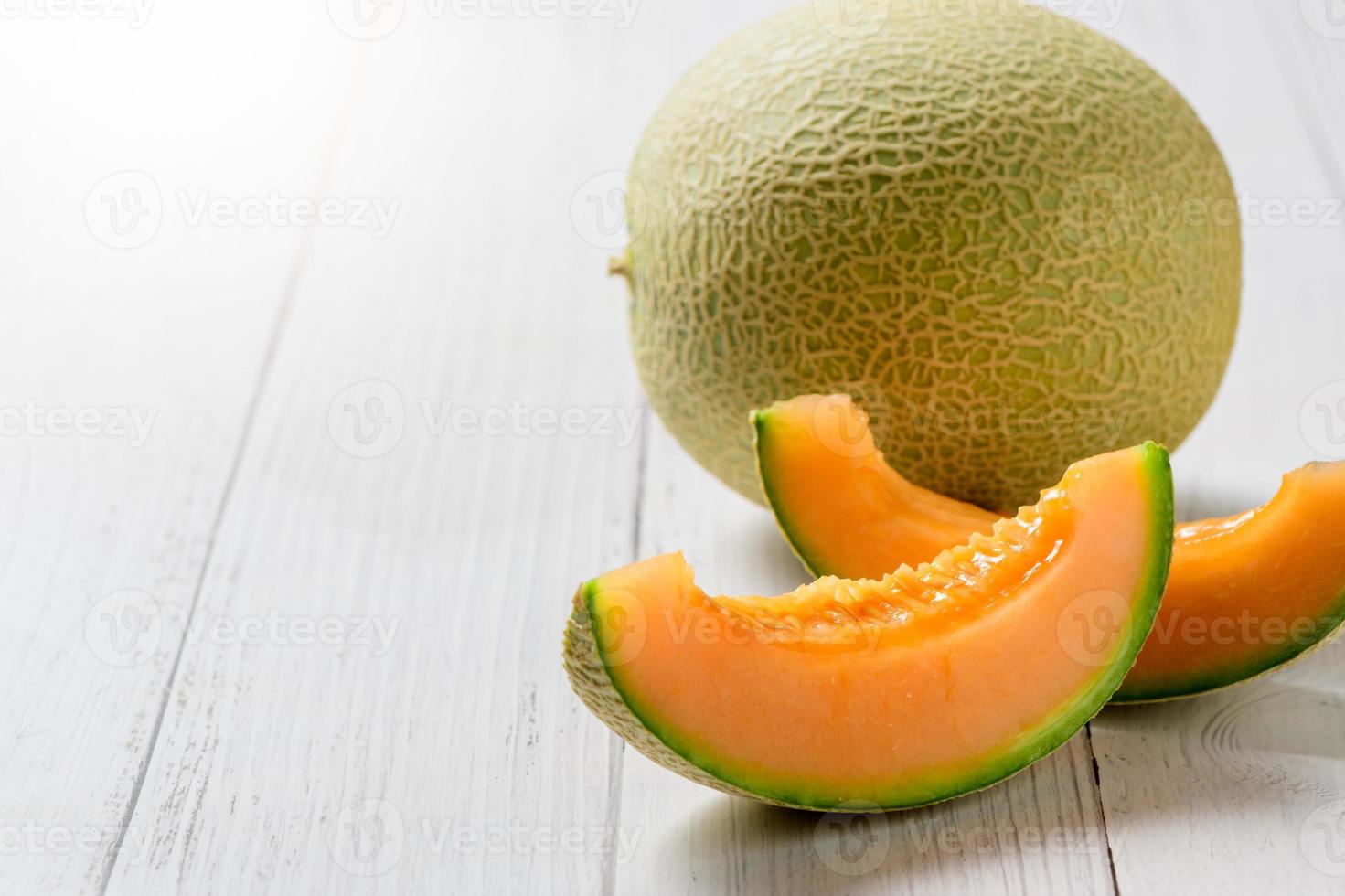sliced of Japanese melons,honey melon or cantaloupe on white wooden table photo
