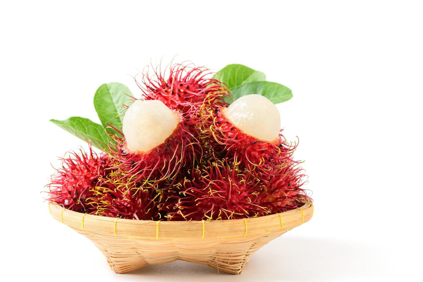 Fresh Rambutan fruits on bamboo basket isolated on white background. fruit Southeast Asia. photo