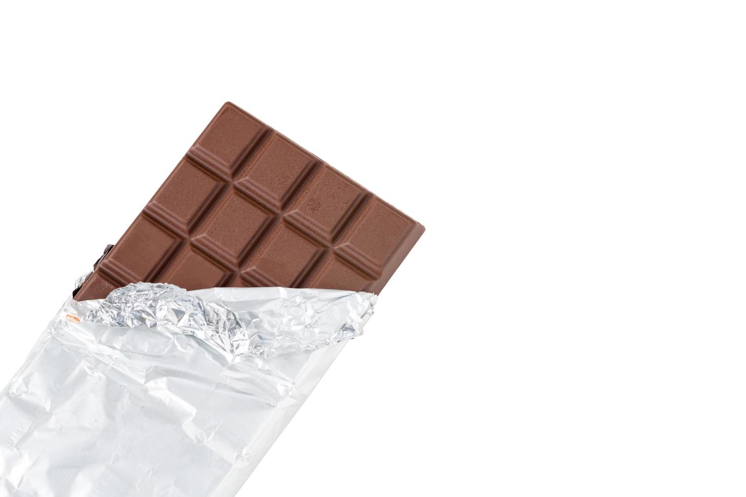 Milk chocolate bar in foil. isolated on white with cliping path photo