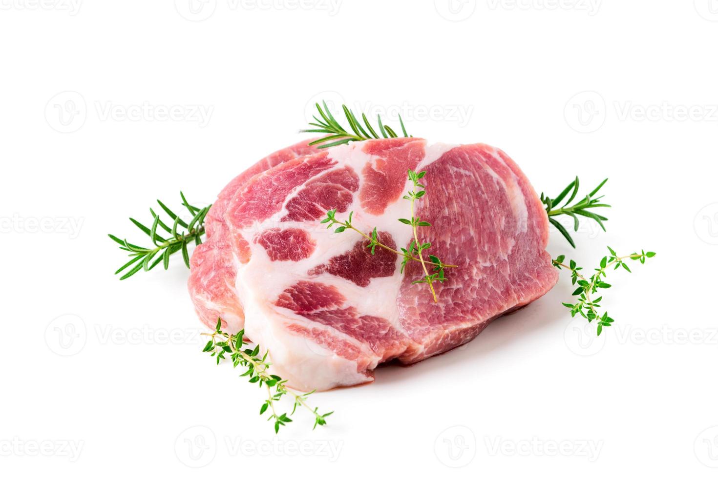 Pieces of pork meat with rosemary and thyme leaves on isolated on white photo