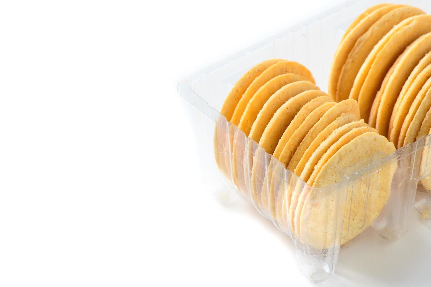 Round Crackers biscuits in plastic box isolated on white background, photo