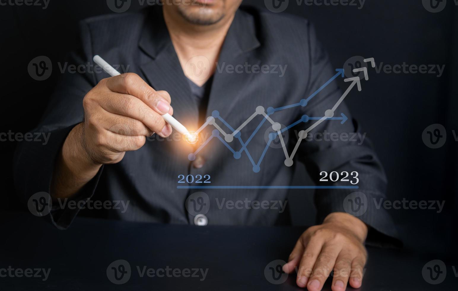 businessman hold Stylus Pen and calculates financial data for long-term investments. photo