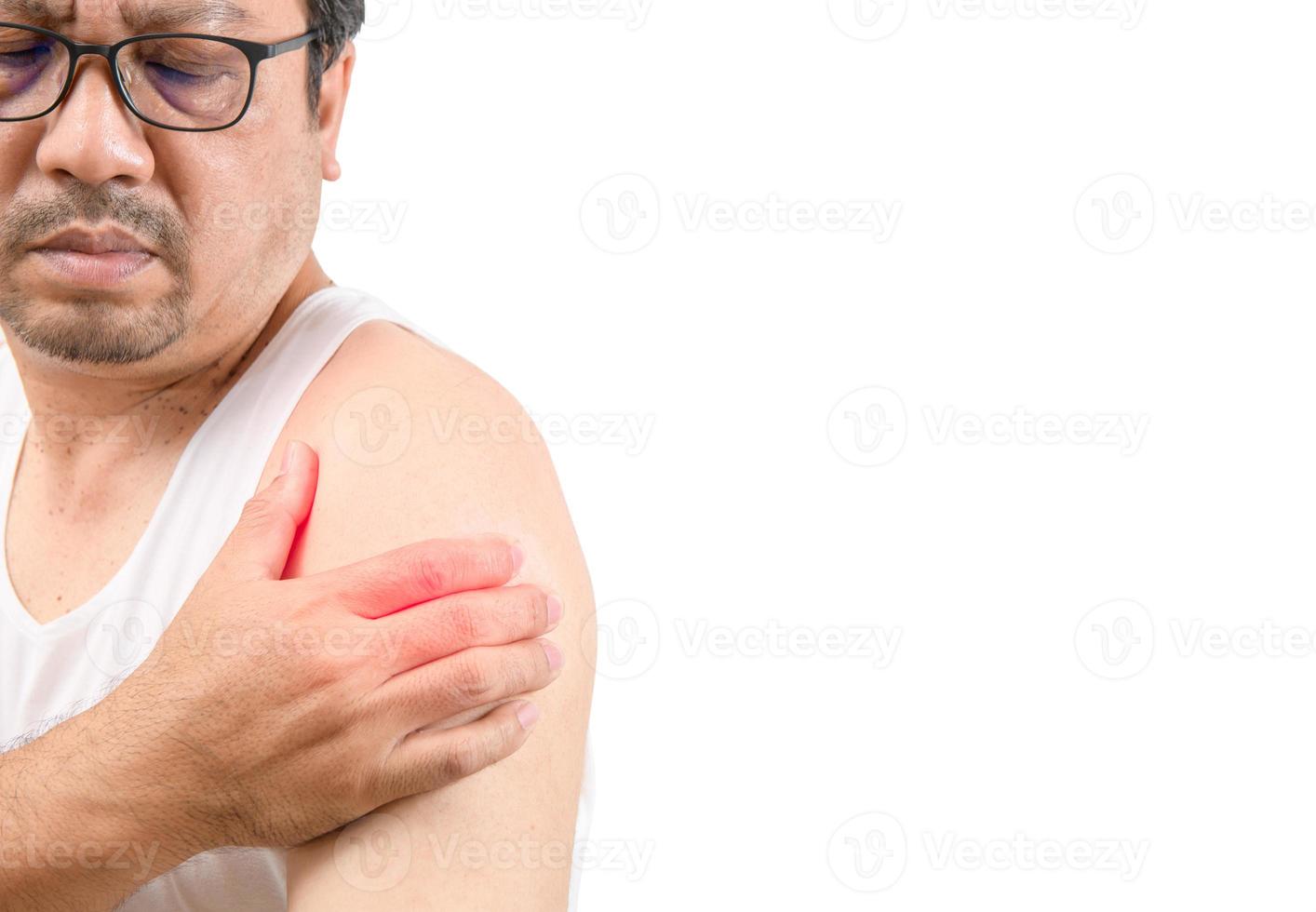 A middle aged man in white veat suffering from arm and shoulder pain isolated on white. photo