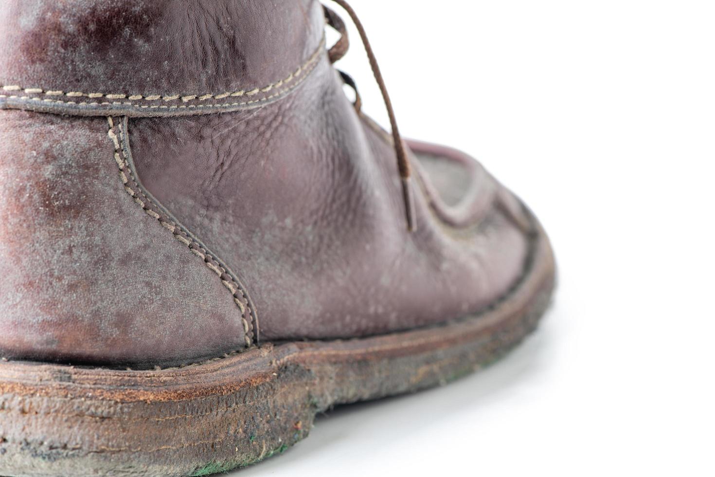 Fungus on brown leather boots shoes isolated on white photo