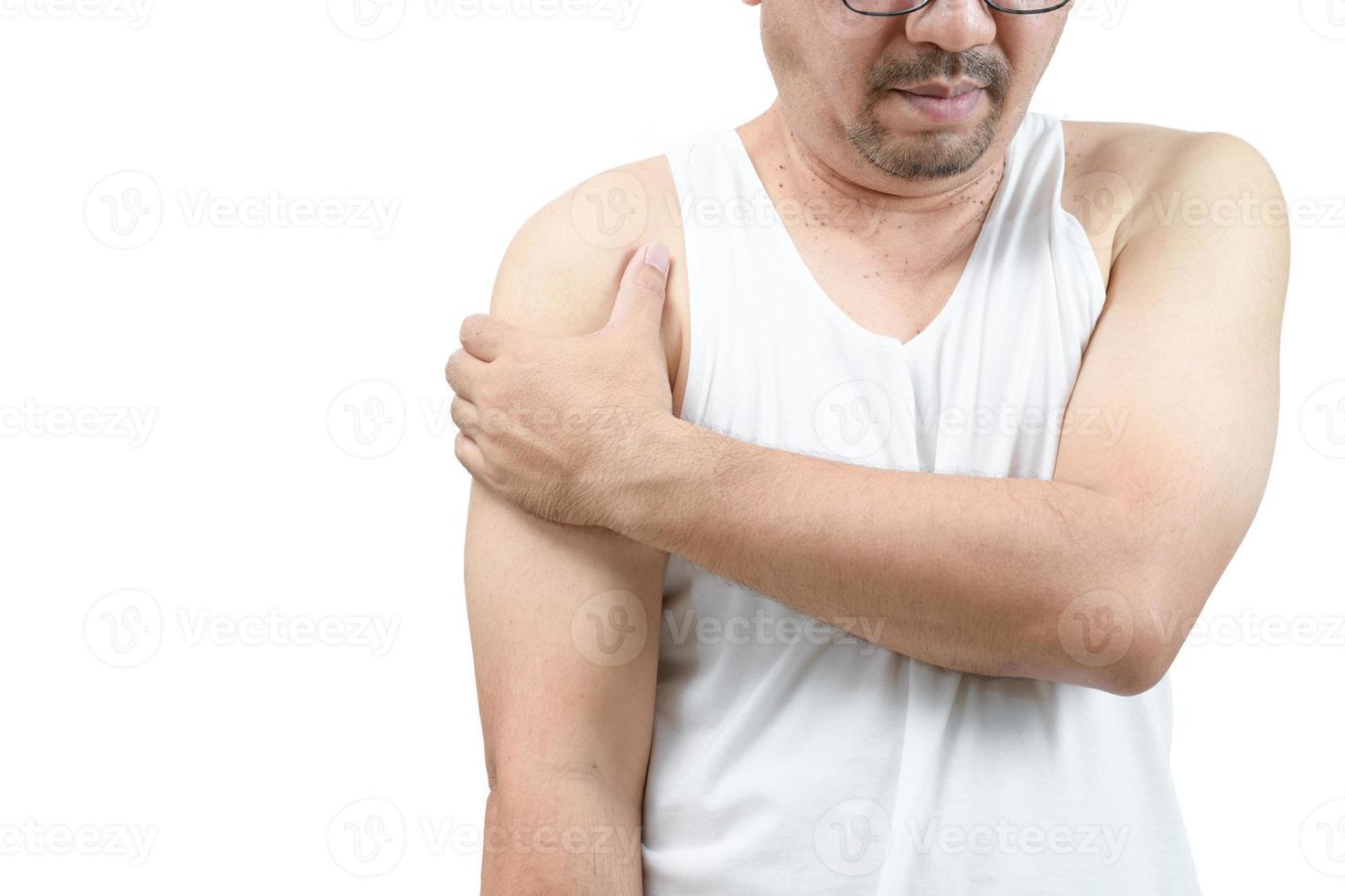 A middle aged man in white veat suffering from arm and shoulder pain isolated photo