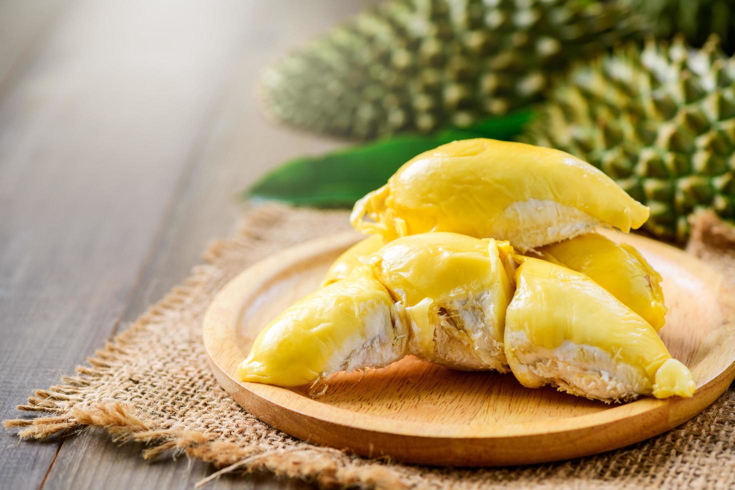Puangmanee durian on wood plate and wood background, photo