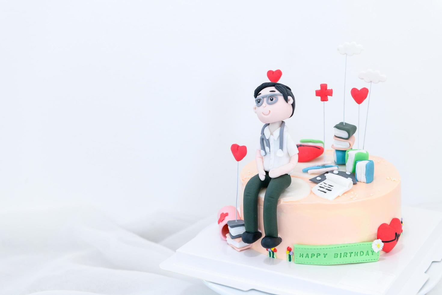 doctor fondant and equipment for doctors on vanilla cake, Homemade cake photo