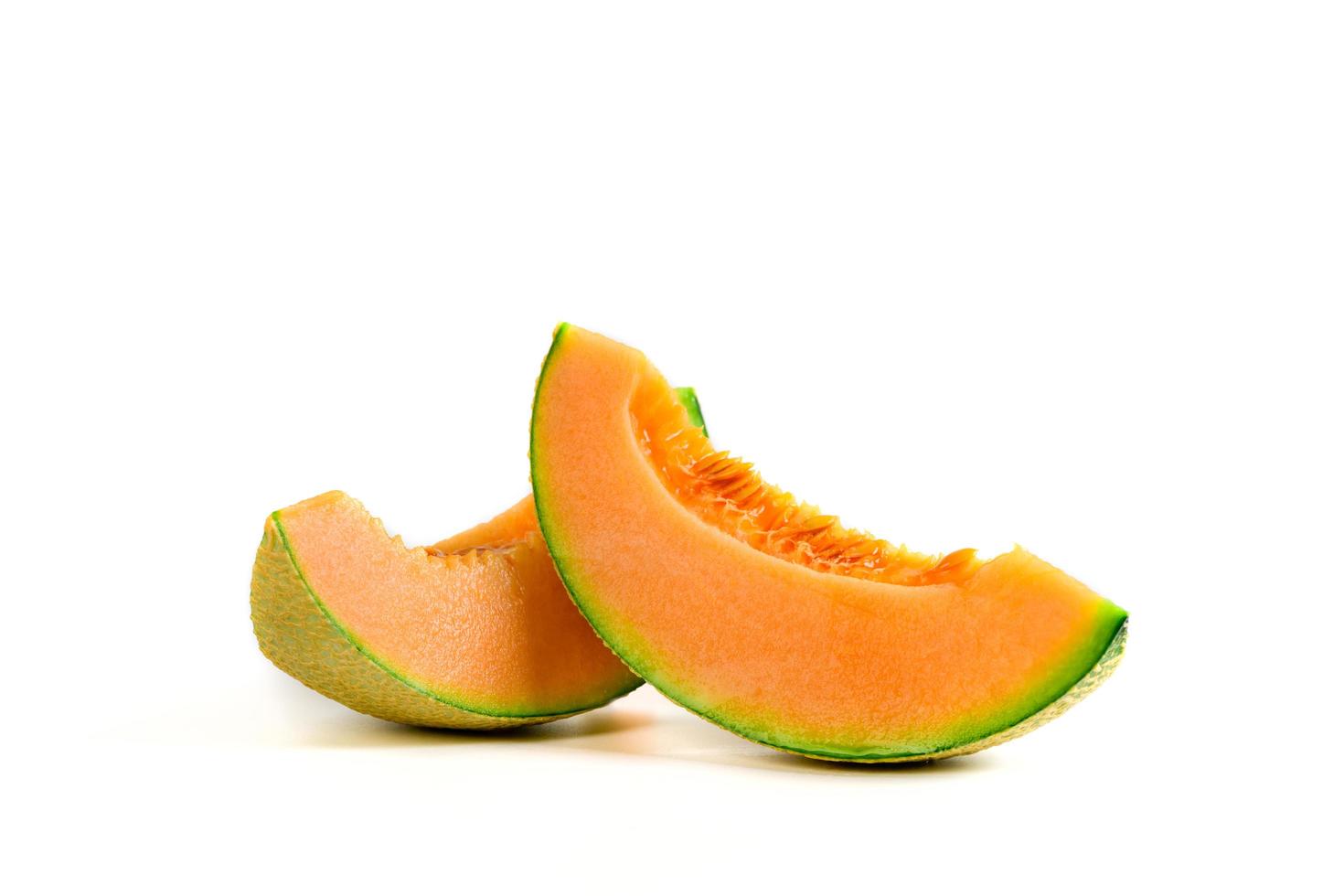 slice of japanese melons, orange melon or cantaloupe melon with seeds isolated on white photo