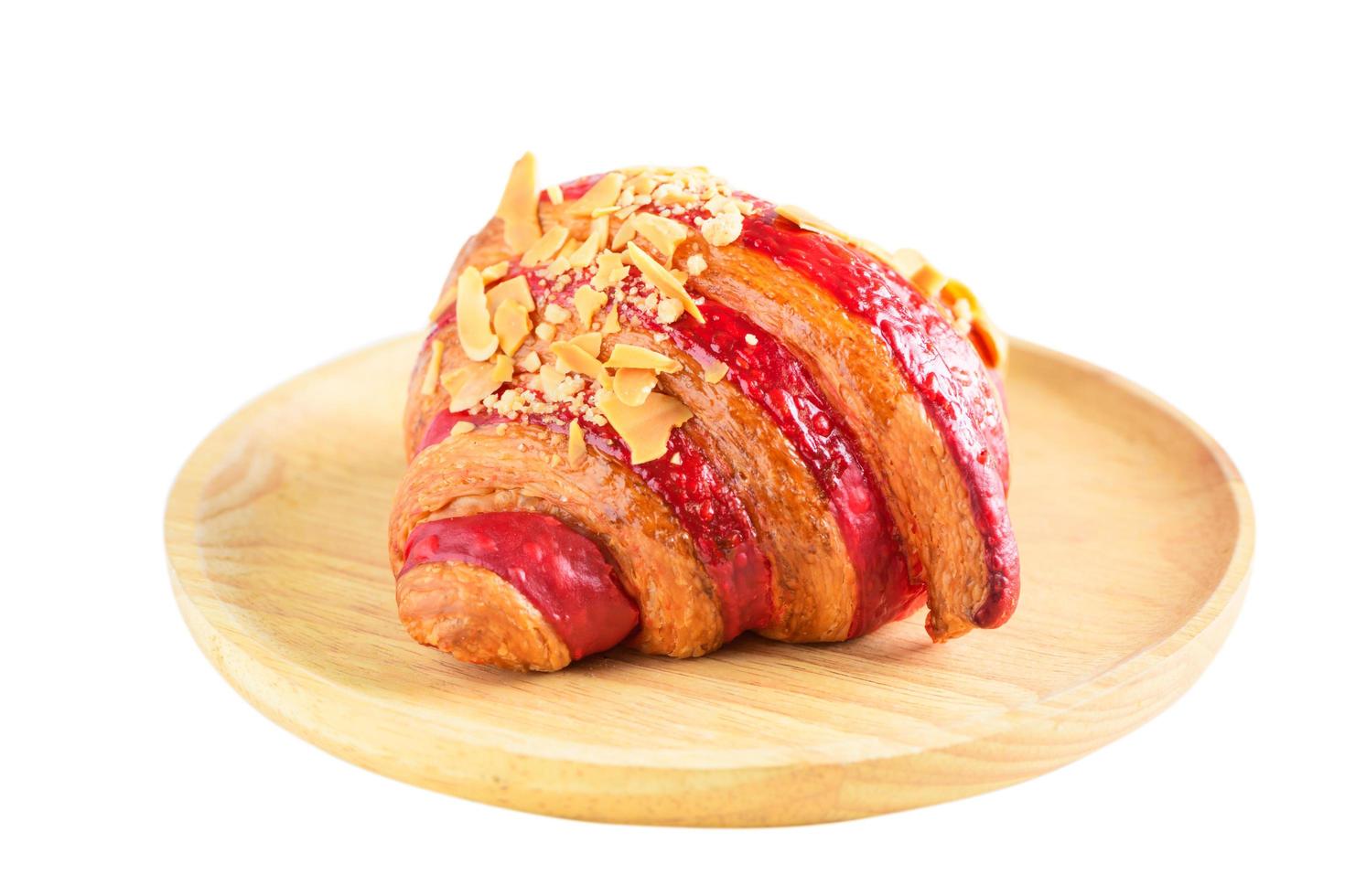 Raspberry Crumble Cream Cheese Croissant on wood plate isolated photo