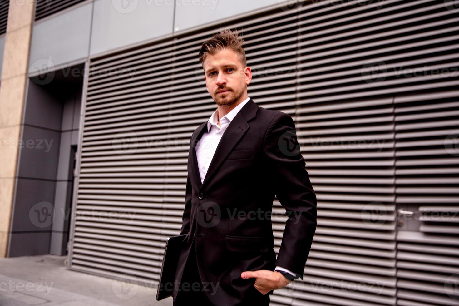 Portrait of a young businessman in a business center photo