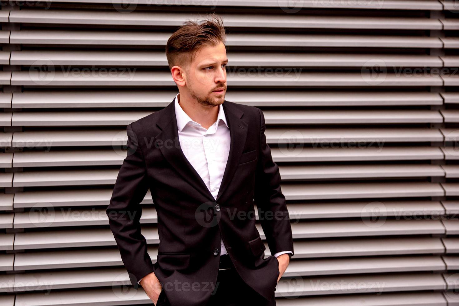 Portrait of a young businessman in a business center photo