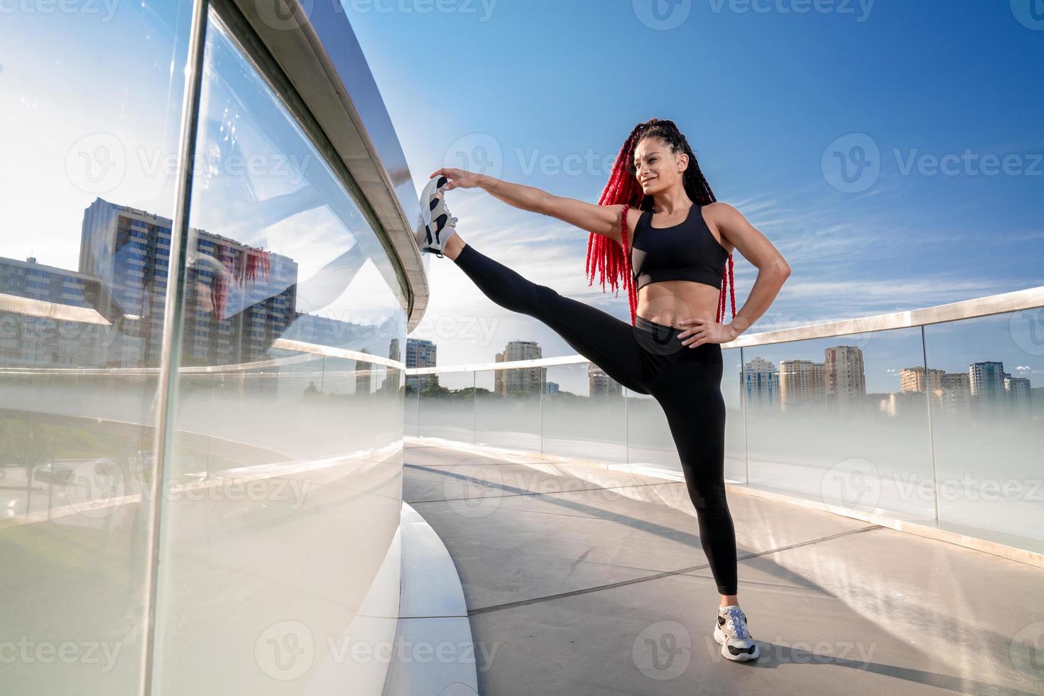Fitness, exercise and a woman stretching at gym during warm up workout and training for health and wellness. Sports female or athlete on ground to stretch legs to be flexible, balance and healthy photo