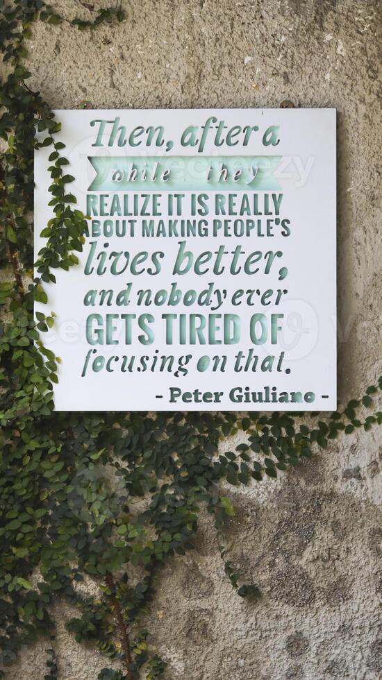 A frame on the wall write Then, after a while realize is really about making people's lives better, and nobody ever gets tired of focusing on that by Peter Giuliano. photo