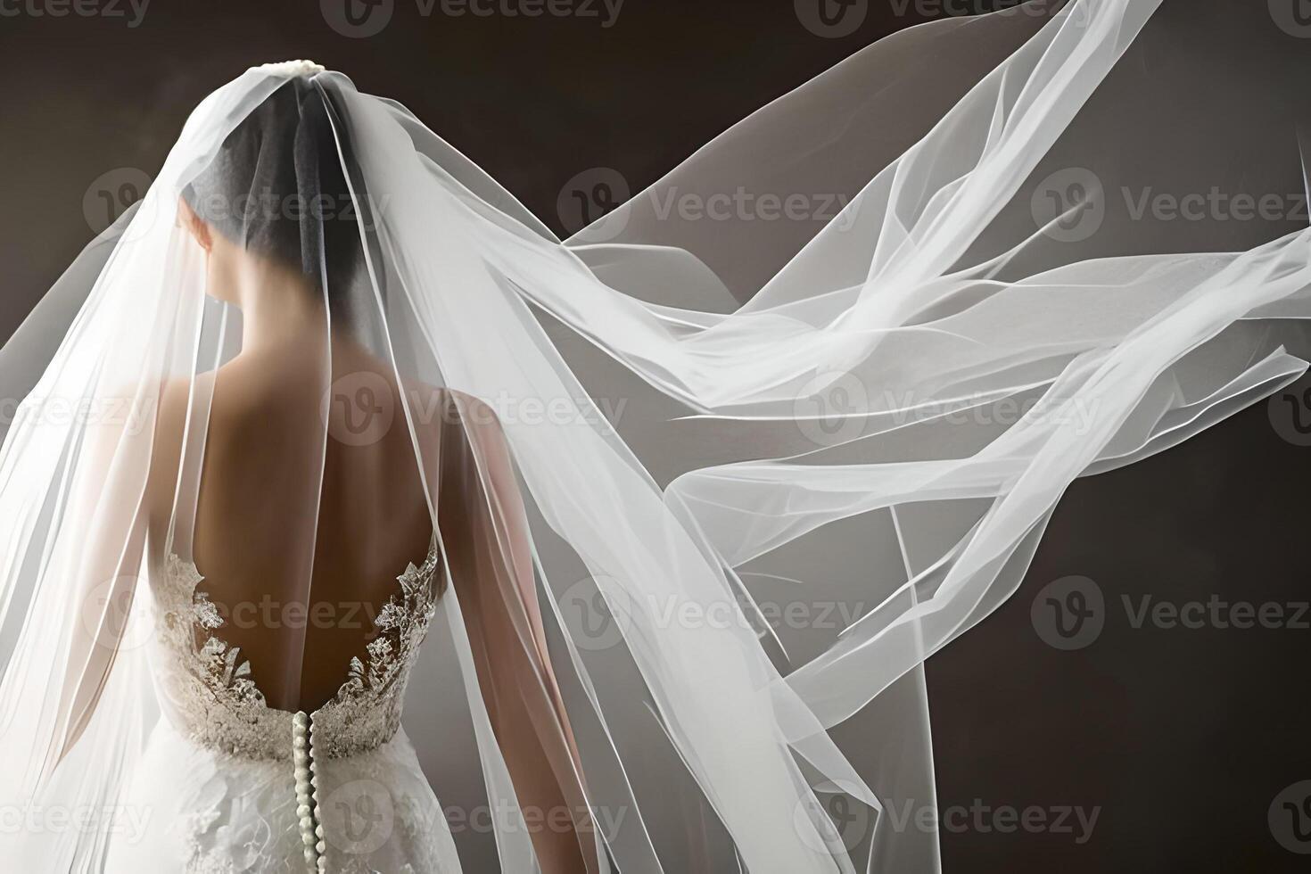 Close up detail a bride from behind in a white wedding dress. photo