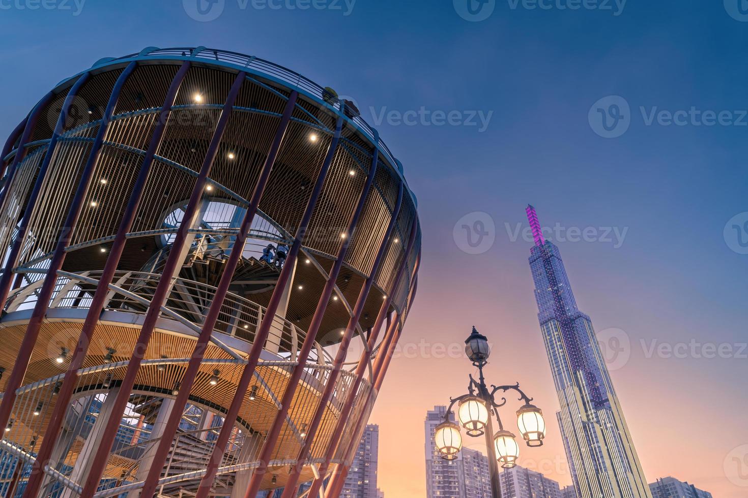 Beautiful night view with colorful sky at Landmark 81 - it is a super tall skyscraper with development buildings along Saigon river in Ho Chi Minh city, Vietnam. photo