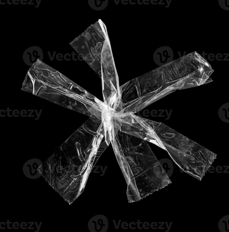 adhesive plastic tape isolated on black background photo