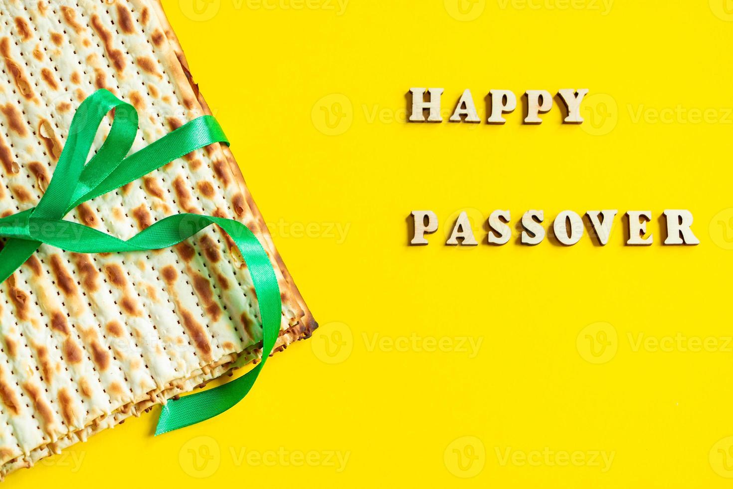 Traditional Jewish matzo on a yellow background. Happy Passover. Pesach religious holiday celebration concept. Matzah bread. photo