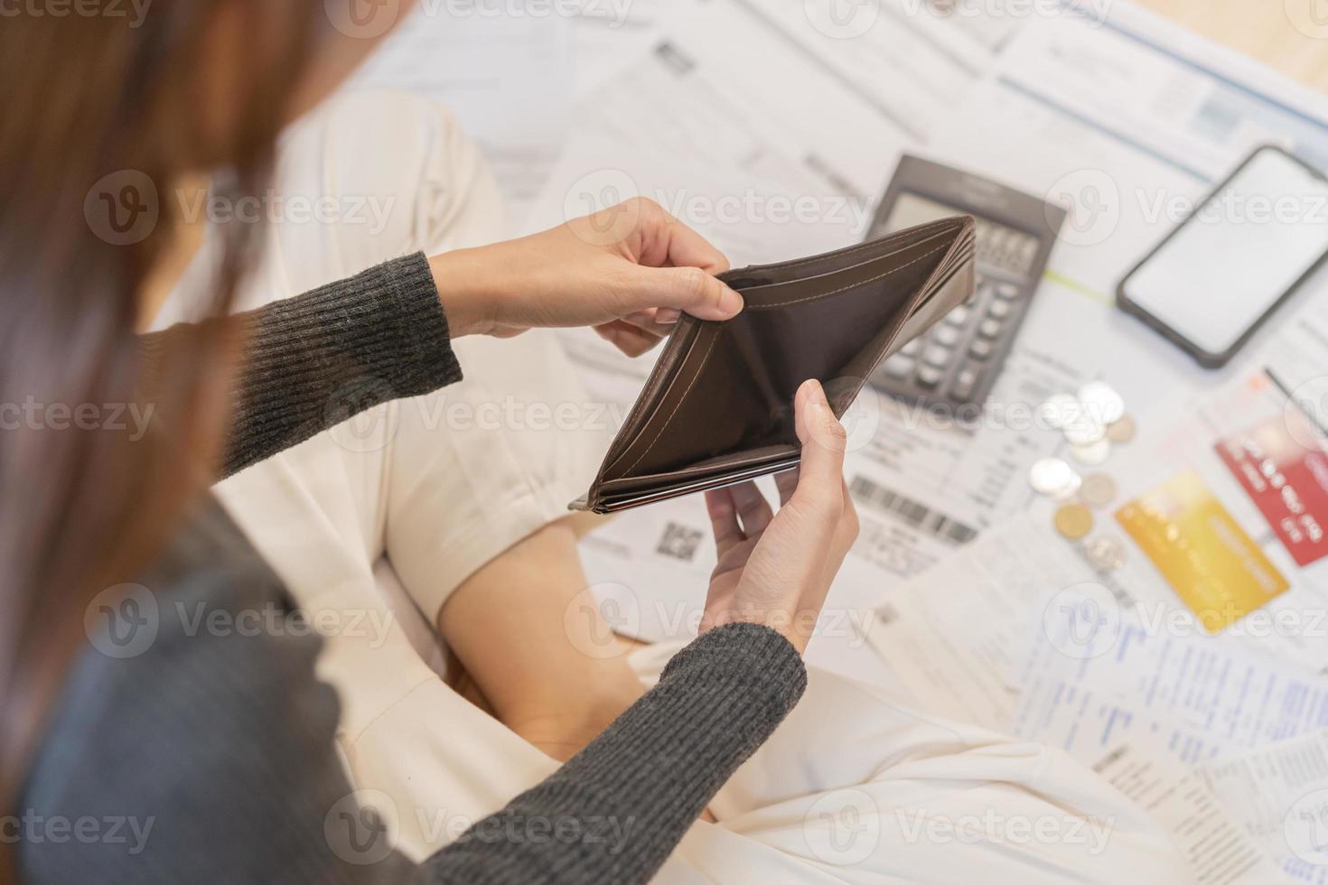 Stressed, Problem people asian woman, girl holding and open an empty wallet not have money, credit card, not to payment bill, loan or expense in pay. Bankruptcy, bankrupt and debt financial concept. photo