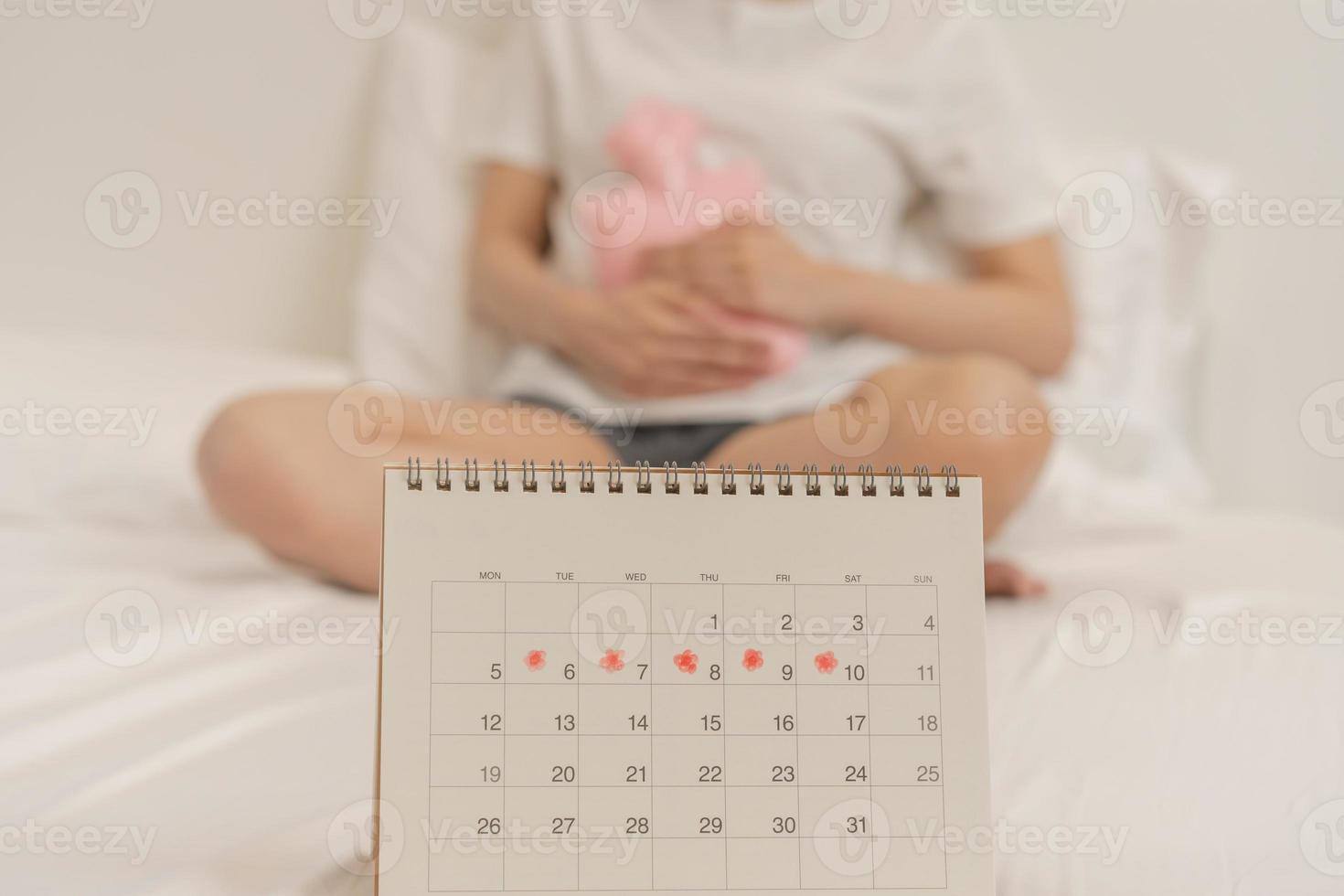 Menstruation, period cycle of monthly, hurt asian young woman, female hand in stomachache, suffer from premenstrual, belly or abdomen pain, using hot water bottle. Health problem Inflammation in body. photo