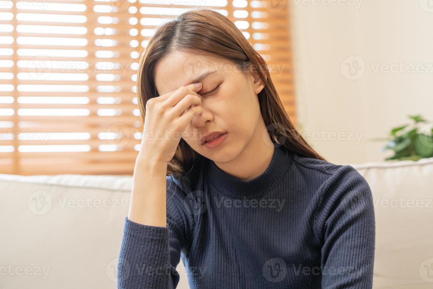 Burnout, weary asian young woman, girl have eyestrain, dizzy, hand touch nose, expression to face difficulty, failure and exhausted. Tired, bad or suffering depression feeling bored alone at home. photo