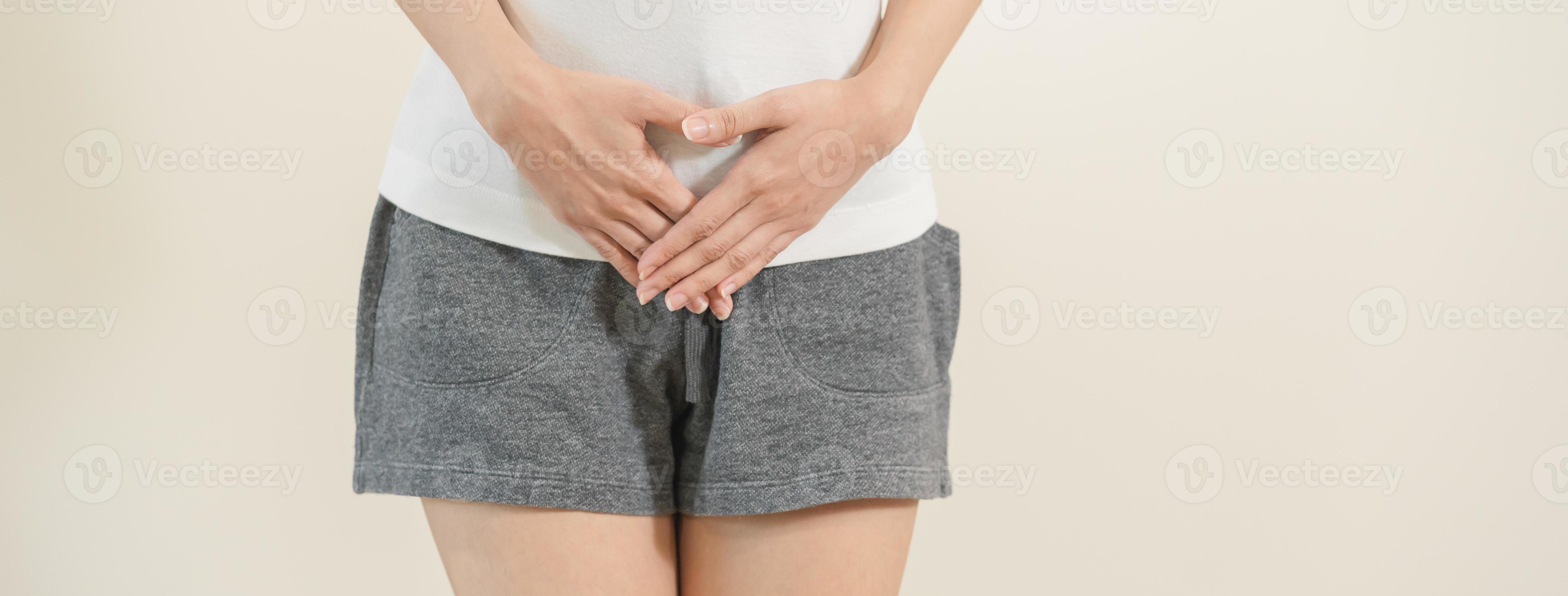 Vaginal, urinary incontinence. Pain asian young woman hand holding