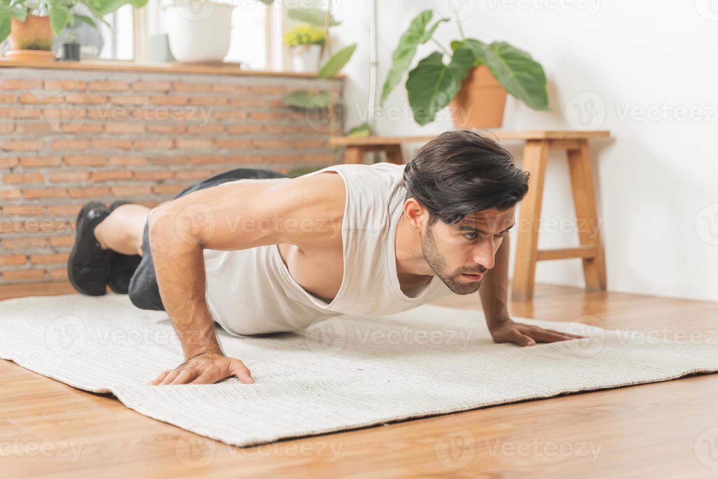 hermoso aptitud caucásico joven hombre, chico vistiendo ropa de deporte formación fuerza músculos ejercicio, ejercicio formación en vivo habitación a hogar para sano cuerpo fuerte atlético, ajuste activo estilo de vida. foto