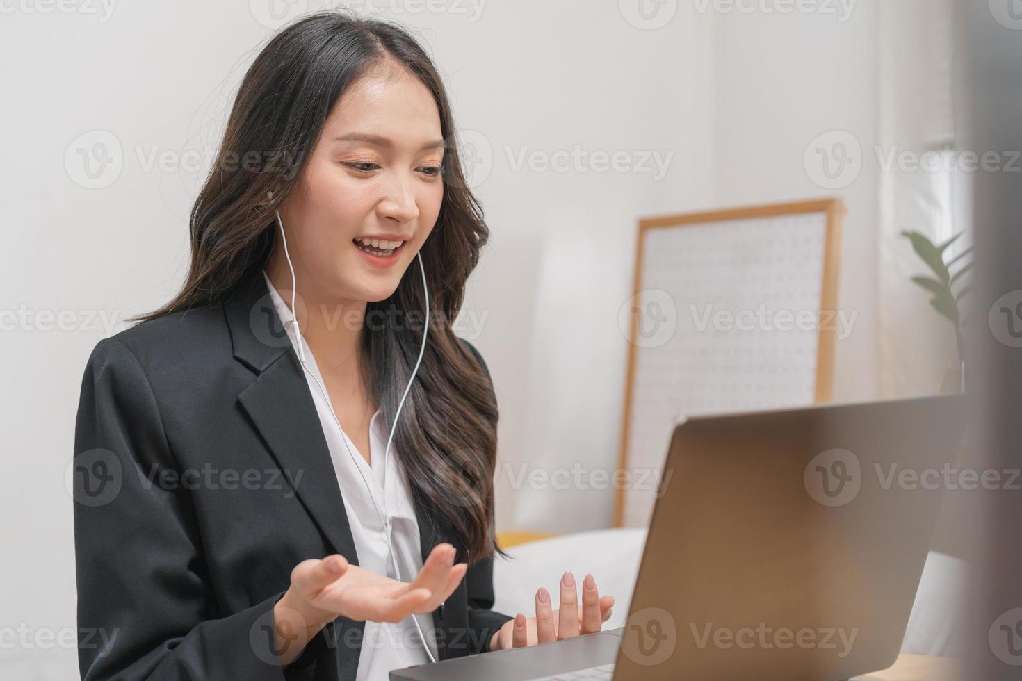 Online communication, attractive asian young woman in formal suit, using laptop computer having online virtual job interview meeting conversation on video call, distance remote recruitment conference. photo
