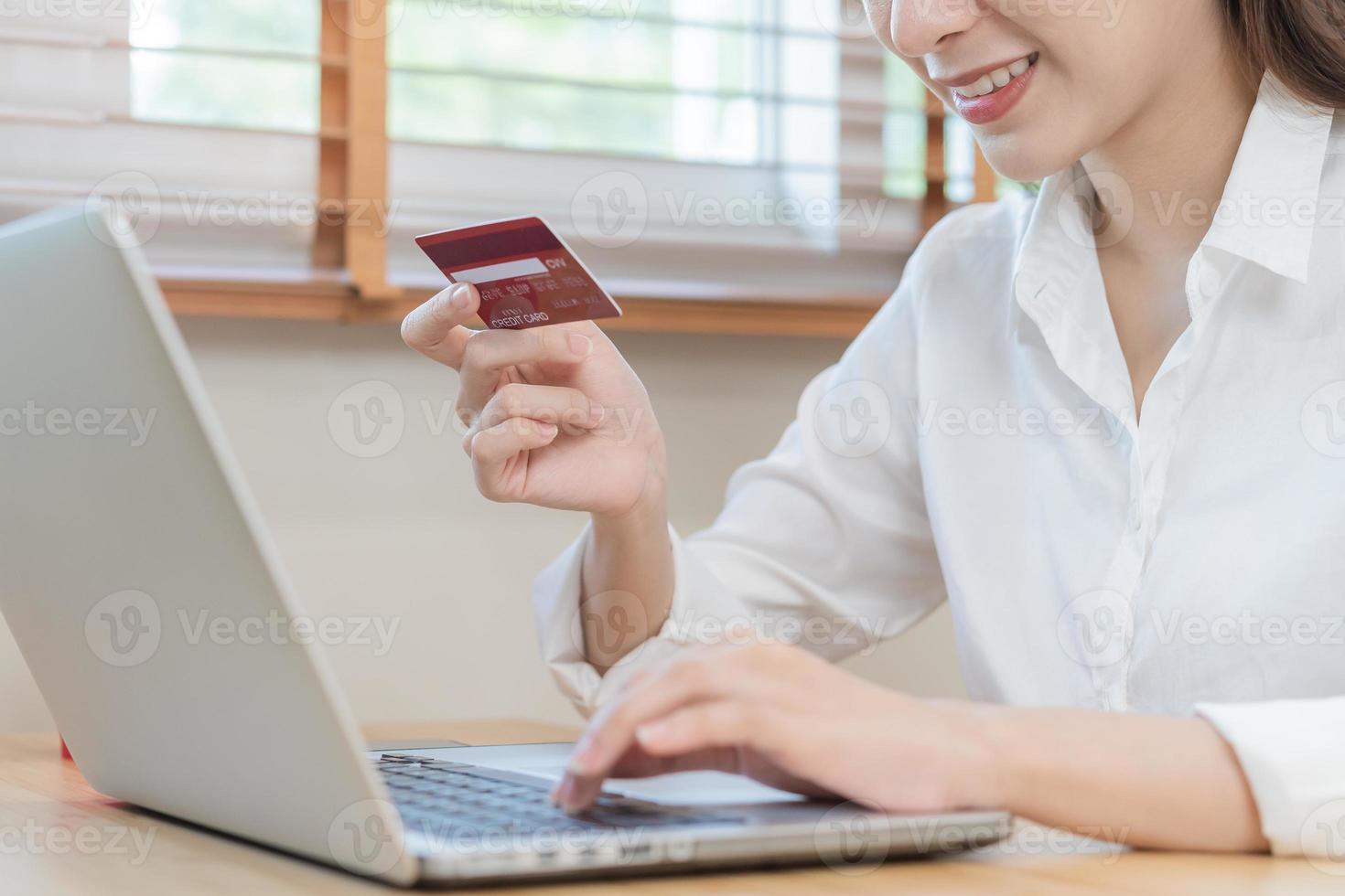 Internet banking, Online shopping at home, happy asian young woman, girl hand in holding credit card, using laptop computer, spending money with purchase, pay on store at home. Shopaholic e-commerce. photo