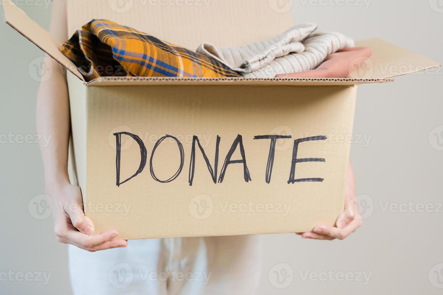 Recycling, Donation for poor, asian young woman pack, hand in holding donate box full with second hand clothes, charity helping and needy people. Reuse recycle, moving of object on white background. photo