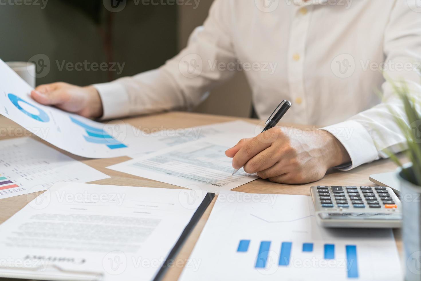 Close up hand of stress asian young employee business man, male calculate tax income and expenses, bills, credit card for payment or payday on table at home office. Financial, finance people concept. photo