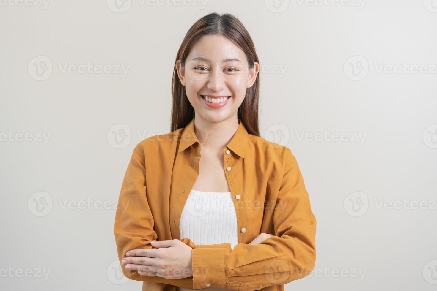 Smile positive, attractive asian young woman wearing casual, portrait of beautiful brunette her with long hair, feeling happy looking at camera, standing cross arms chest isolated on white background. photo
