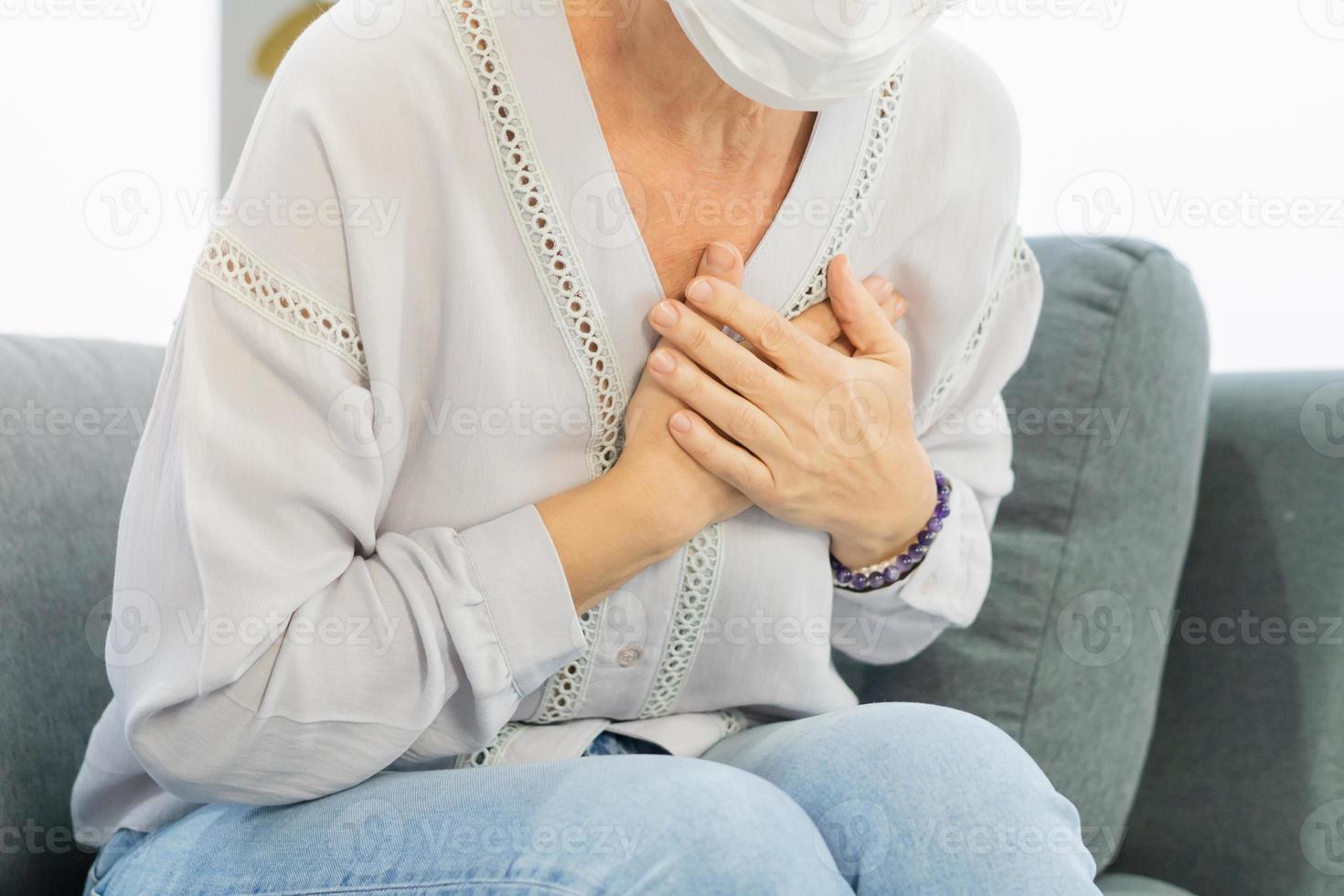 Cardiology, angina caucasian mature woman hand hold chest with pain and suffer, having heart attack, hurt sudden coronary symptom arrhythmia, palpitation. Health care, heart disease of senior older. photo