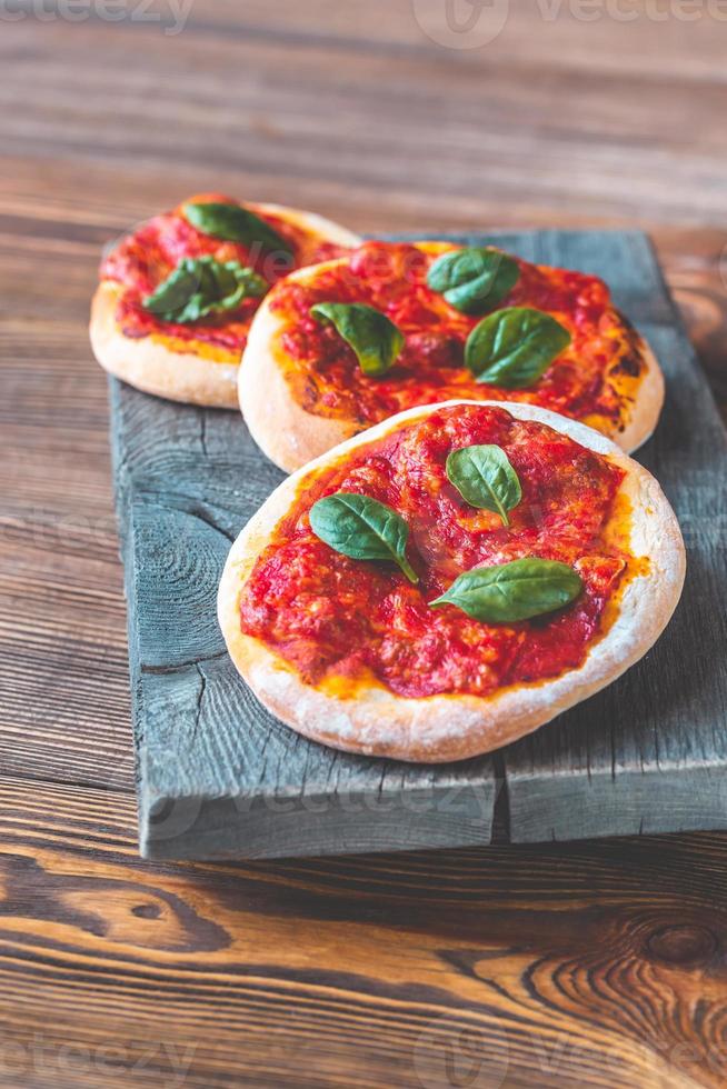Mini Margherita pizzas with red cheese photo