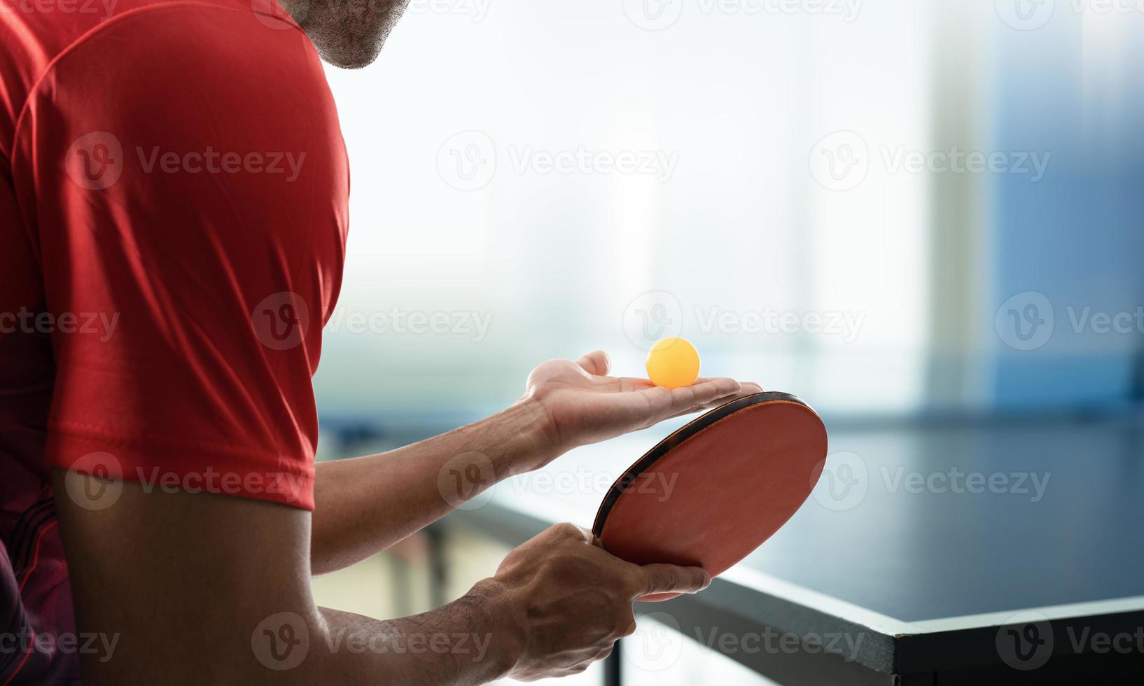 Young athlete playing ping pong with determination in victory playing photo